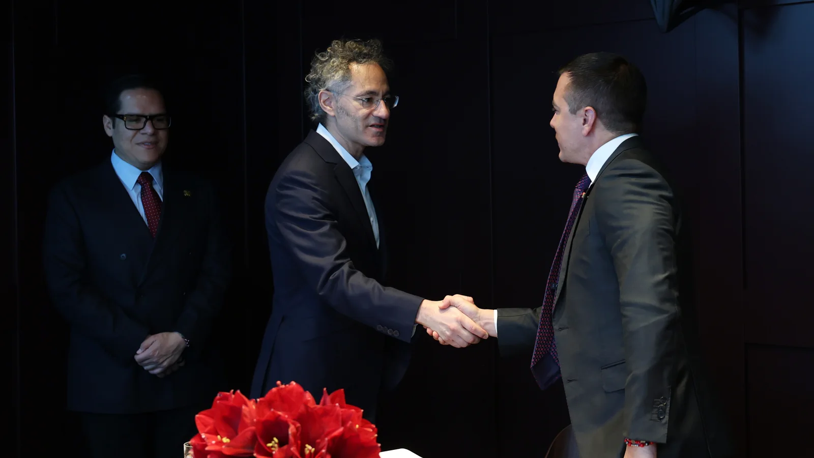 Palantir CEO Alex Karp shaking hands with Ecuadorian President Daniel Noboa at the World Economic Forum in Davos.