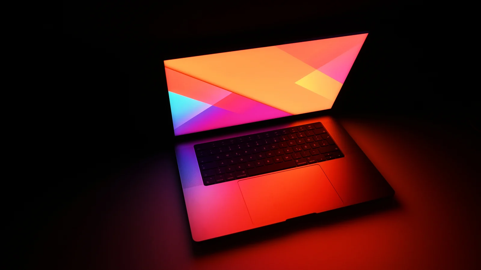 A laptop computer is visible on a dark surface.