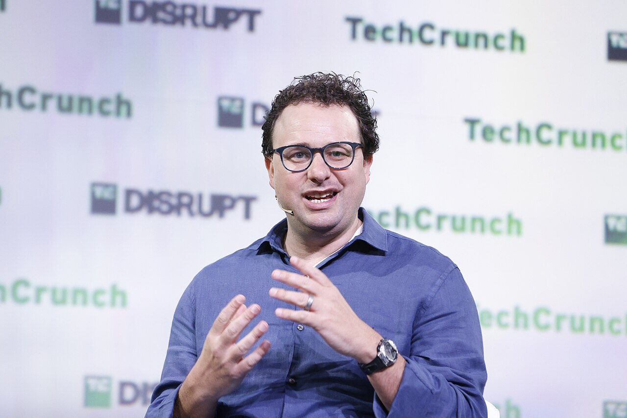 Dario Amodei speaking during a seated interview at TechCrunch Disrupt 2023.