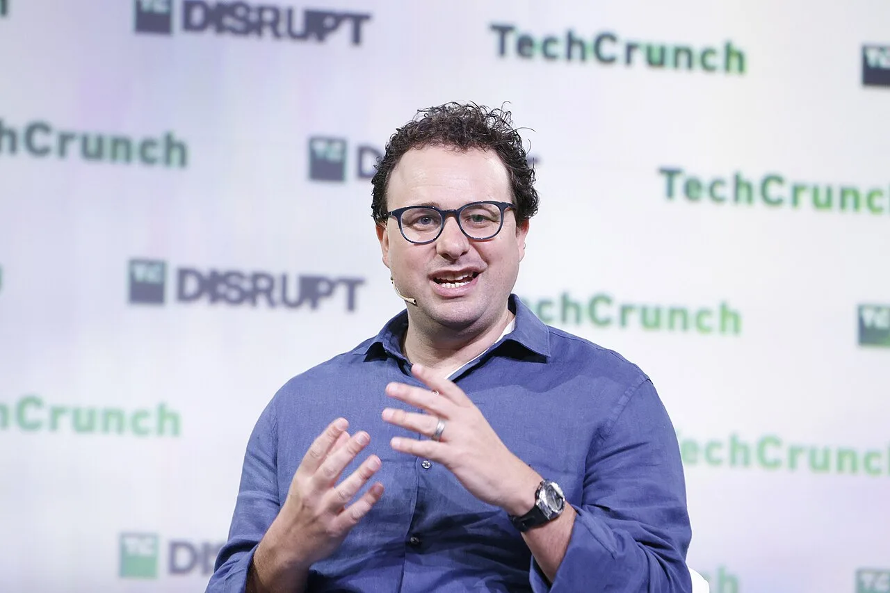 Dario Amodei speaking during a seated interview at TechCrunch Disrupt 2023.