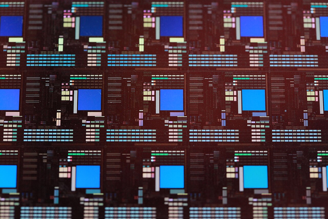 Close-up view of chips on a semiconductor wafer, representing custom AI hardware and the infrastructure behind advanced AI systems.