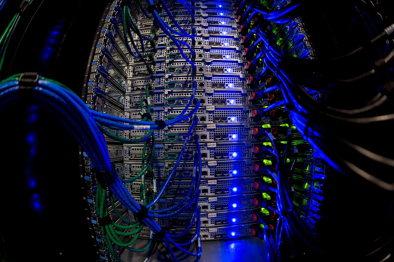 Close-up view of server racks and network cables, representing the infrastructure layer behind AI deployment.
