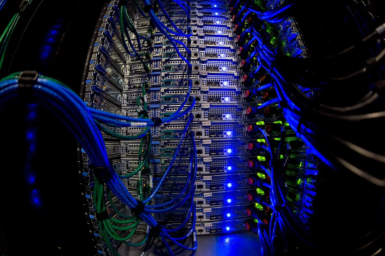 Close-up view of server racks and network cables, representing the infrastructure layer behind AI deployment.